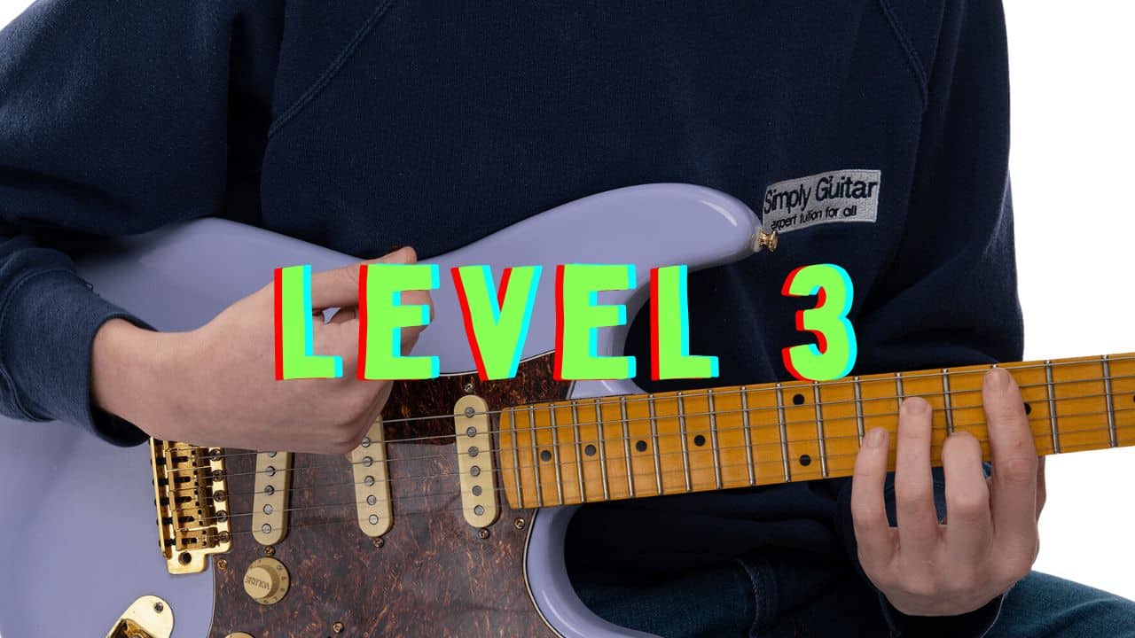person with guitar in lap with level 3 in green text above it